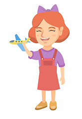 Image showing Caucasian cheerful girl playing with toy airplane.