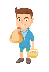 Image showing Caucasian boy holding a chicken and hen eggs.