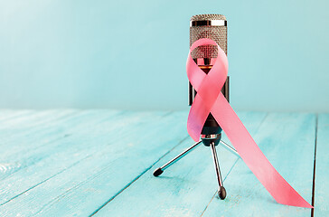 Image showing the text world cancer day and a pink ribbon on a table background