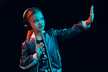 Image showing Young girl with headphones enjoying music