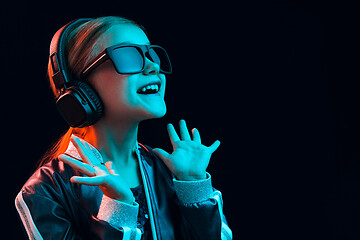 Image showing Young girl with headphones enjoying music