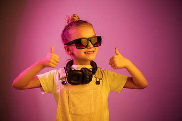 Image showing Young girl with headphones enjoying music