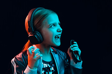 Image showing Young girl with headphones enjoying music