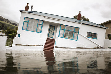 Image showing Flooding with a crooked house