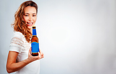 Image showing smiling woman with bottle