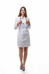 Image showing girl doctor in white robe with stethoscope on white background