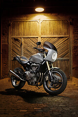 Image showing Custom caferacer motorbike on an old garage door background.