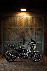 Image showing Custom caferacer motorbike on an old garage door background.