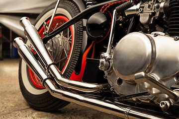 Image showing Custom bobber motorbike in an workshop garage.