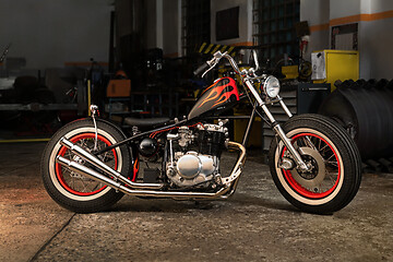 Image showing Custom bobber motorbike in an workshop garage.