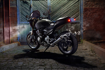 Image showing Custom caferacer motorbike on an old garage door background.