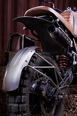 Image showing Custom scrambler motorbike on a rusty container background.