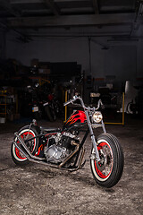 Image showing Custom bobber motorbike in an workshop garage.