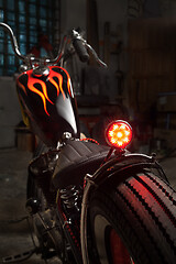 Image showing Custom bobber motorbike in an workshop garage.