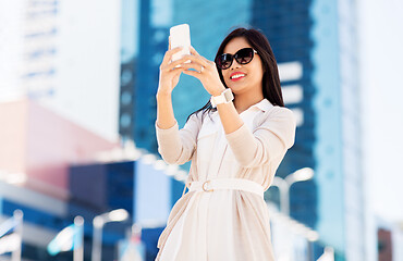 Image showing asian woman taking selfie by smartphone in city