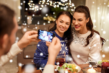 Image showing friends having christmas dinner and taking picture