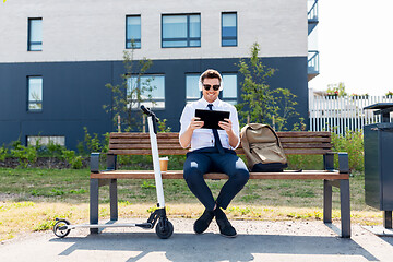 Image showing businessman with tablet pc, headphones and scooter