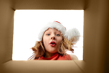 Image showing surprised girl looking into christmas gift box