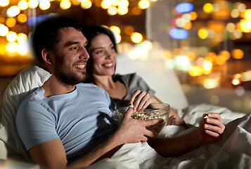 Image showing couple with popcorn watching tv at night at home