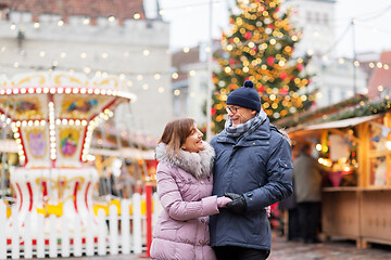 Image showing happy senior couple hugging at christmas market