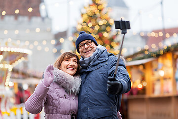 Image showing senior couple taking selfie at christmas market