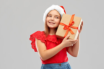 Image showing smiling girl in snata hat with christmas gift