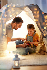 Image showing happy family playing with toy in kids tent at home