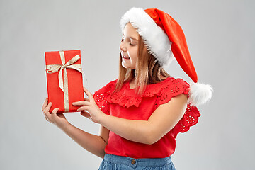 Image showing smiling girl in snata hat with christmas gift