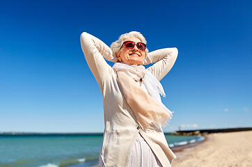 Image showing portrait of senior woman in sunglasses on beach