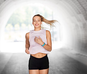 Image showing happy teenage girl running outdoors