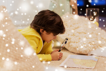 Image showing boy with magnifier and map in kids tent at home