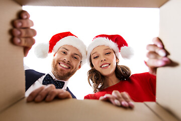 Image showing happy couple opening christmas gift box