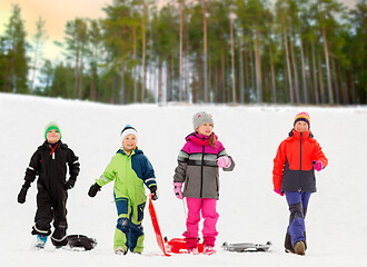 Image showing happy little kids with sleds in winter