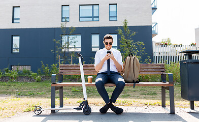 Image showing businessman with smartphone, backpack and scooter