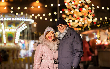 Image showing happy senior couple hugging at christmas market