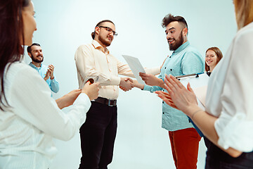 Image showing Boss approving and congratulating young successful employee