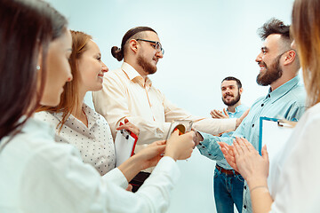 Image showing Boss approving and congratulating young successful employee