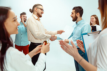 Image showing Boss approving and congratulating young successful employee