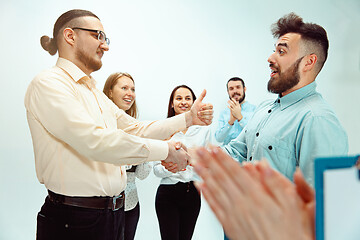 Image showing Boss approving and congratulating young successful employee