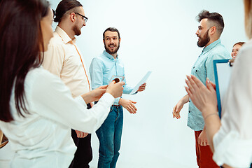 Image showing Boss approving and congratulating young successful employee