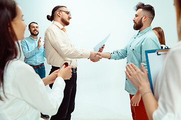 Image showing Boss approving and congratulating young successful employee