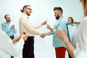 Image showing Boss approving and congratulating young successful employee