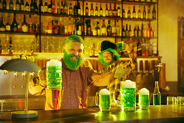 Image showing Happy man with glass of beer looking aside in pub