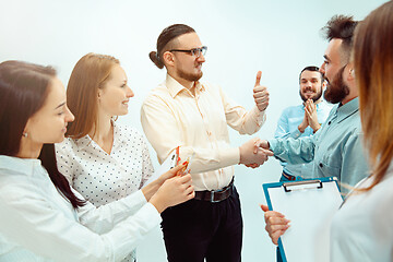 Image showing Boss approving and congratulating young successful employee