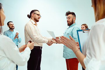 Image showing Boss approving and congratulating young successful employee