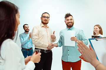 Image showing Boss approving and congratulating young successful employee