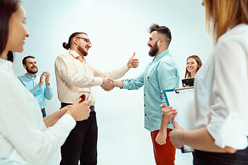 Image showing Boss approving and congratulating young successful employee