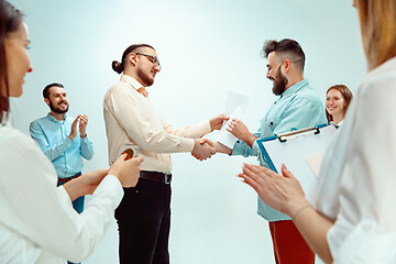 Image showing Boss approving and congratulating young successful employee