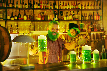 Image showing Happy man with glass of beer looking aside in pub