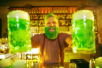 Image showing Happy man with glass of beer looking aside in pub